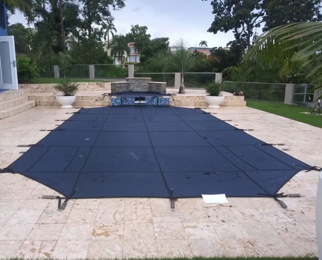 Not just pool cover installation, but Safety Guard Inc. also helps you choose the best anchor for your needs. A Grecian pool covered with blue safety cover.