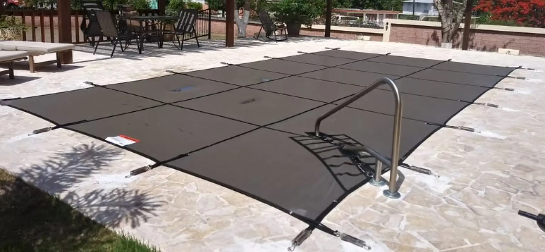 Safety Guard Inc. provides pool cover installation in North Georgia. A rectangular swimming pool with a black safety cover.